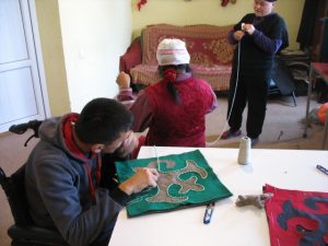 Villagers working with felt